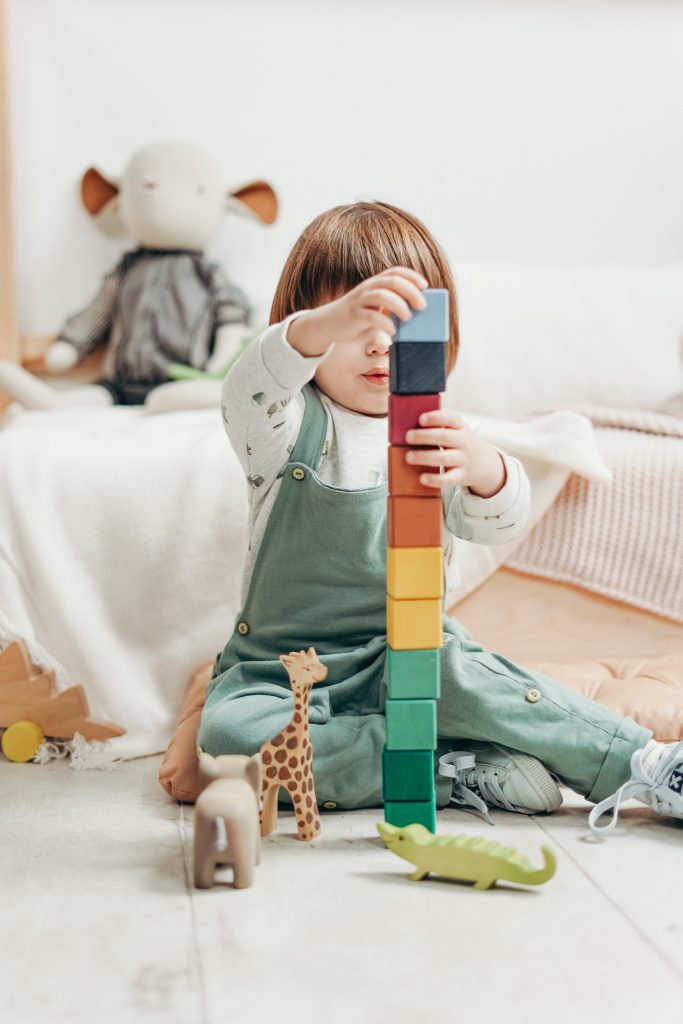 child-in-white-long-sleeve-top-and-dungaree-trousers-playing-3661356