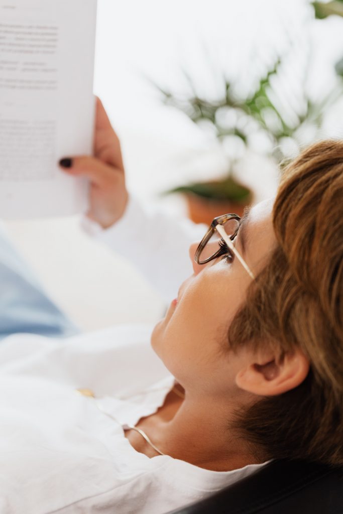 woman-reading-book-in-room-during-vacation-4468167